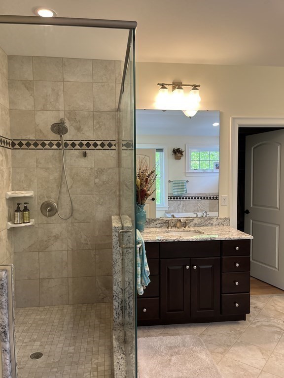 88 Indian Ridge Terrace, Unit 88 Westford, MA 01886 - Photo 26 of 39 a bathroom with a granite countertop sink a toilet and a mirror