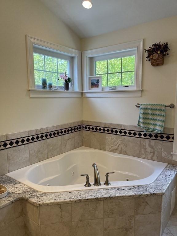 88 Indian Ridge Terrace, Unit 88 Westford, MA 01886 - Photo 27 of 39 a bathroom with a granite countertop tub and a window