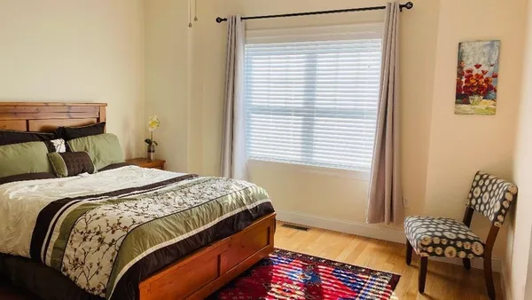 a bedroom with a bed and a dresser in it
