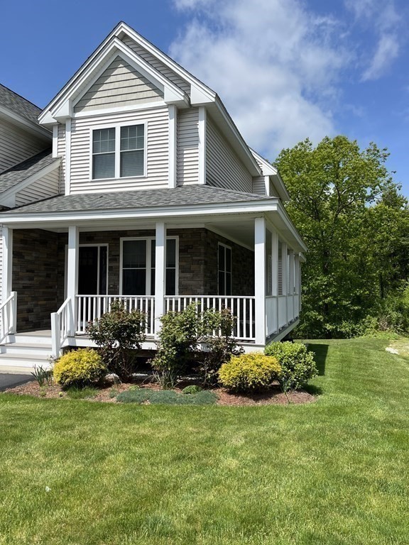 88 Indian Ridge Terrace, Unit 88 Westford, MA 01886 - Photo 3 of 39 a front view of a house with a yard