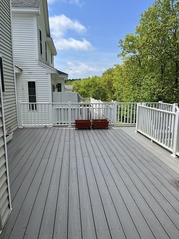88 Indian Ridge Terrace, Unit 88 Westford, MA 01886 - Photo 36 of 39 a view of deck with wooden floor and fence