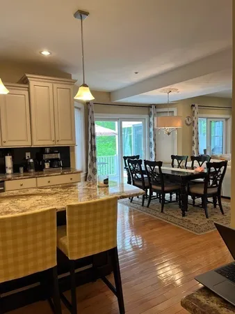 a dining table with chairs and window