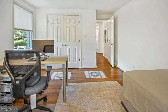 a bedroom with a bed and a table in it