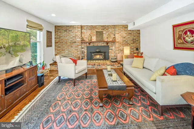 a living room with furniture kitchen view and large windows