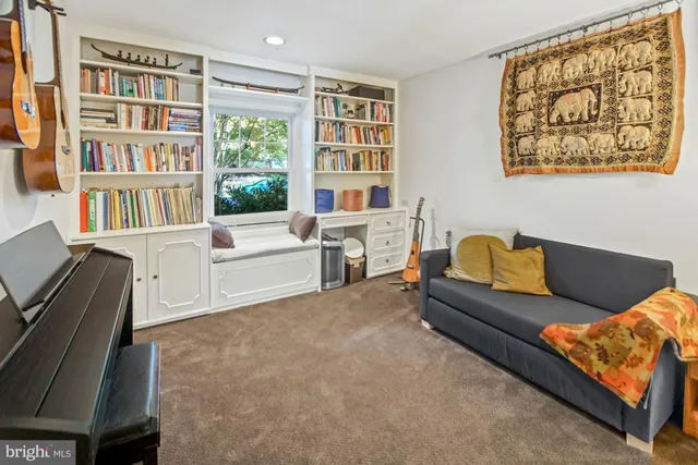 a livingroom with workspace and a window