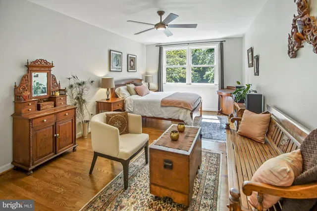 a bedroom with furniture and a flat screen tv