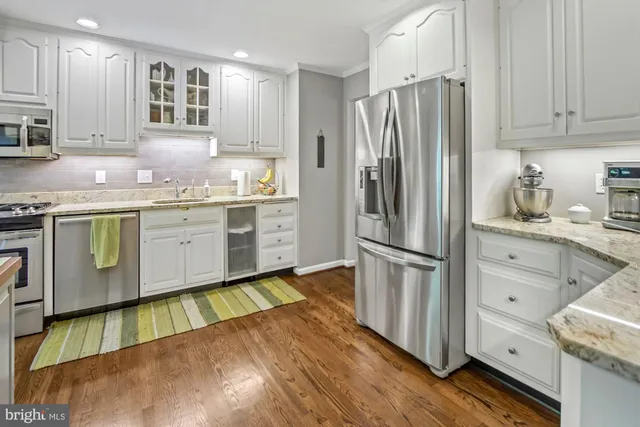 a kitchen with a stove a refrigerator and a sink