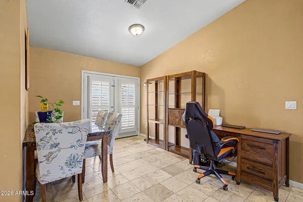 a view of a workspace with furniture and a window