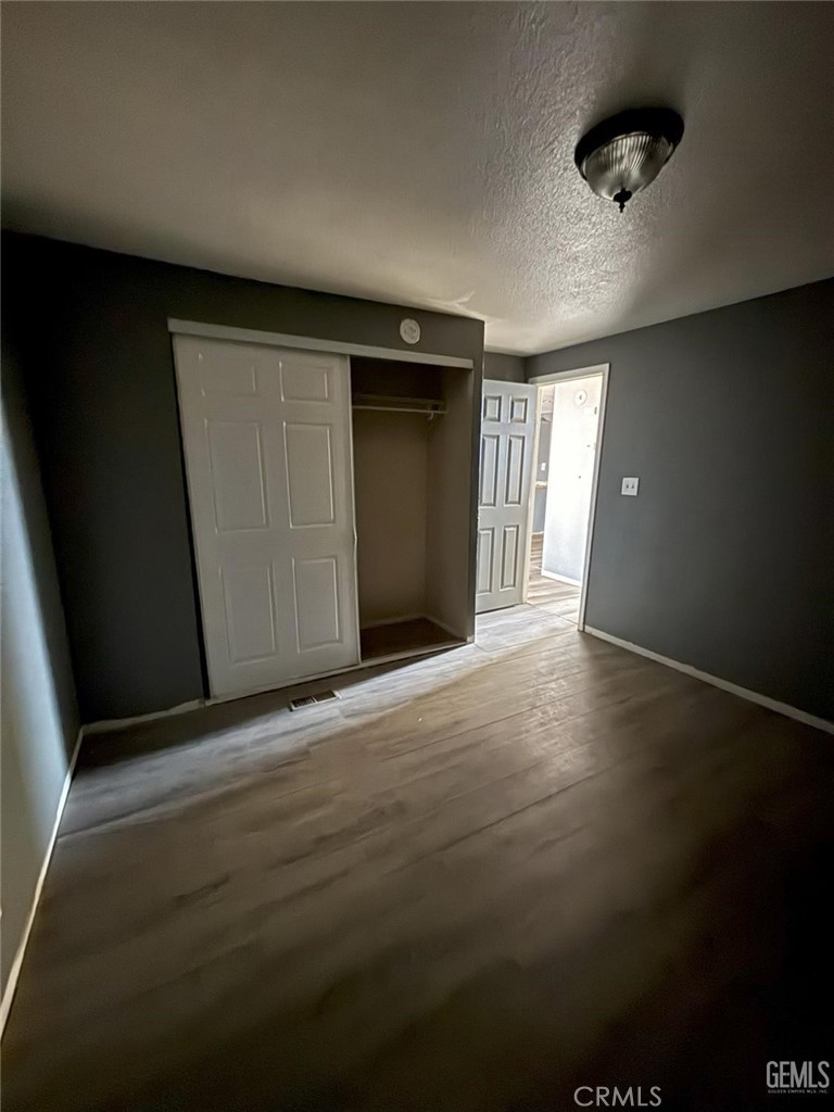1405 West St George Avenue Ridgecrest, CA 93555 - Photo 13 of 27 a view of a livingroom with wooden floor and closet