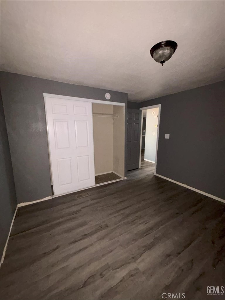 1405 West St George Avenue Ridgecrest, CA 93555 - Photo 14 of 27 a view of an empty room with wooden floor