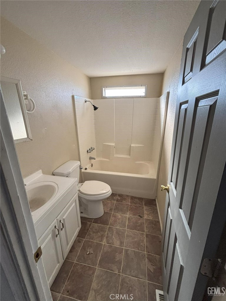 1405 West St George Avenue Ridgecrest, CA 93555 - Photo 15 of 27 a bathroom with a granite countertop sink toilet and shower