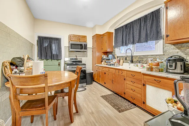 a kitchen with stainless steel appliances kitchen island granite countertop a sink and cabinets