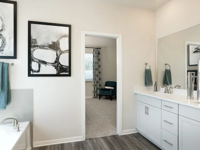 a en suite bathroom with a sink mirror and vanity
