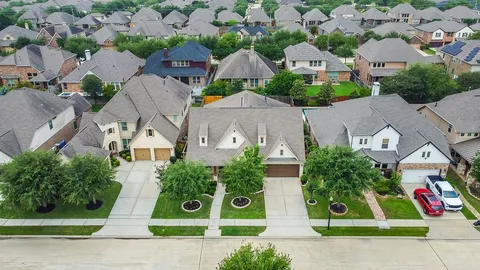 an aerial view of multiple houses with street