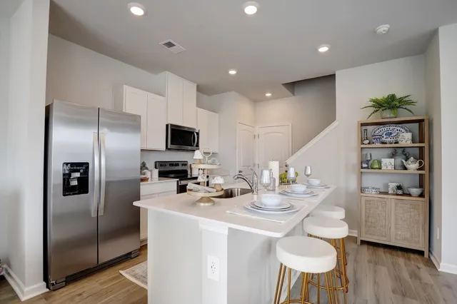 a kitchen with refrigerator and microwave