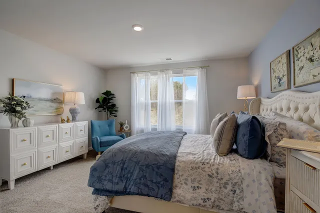 a bedroom with a bed and a potted plant