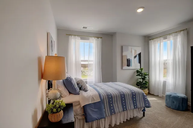 a bedroom with a bed and a table in it