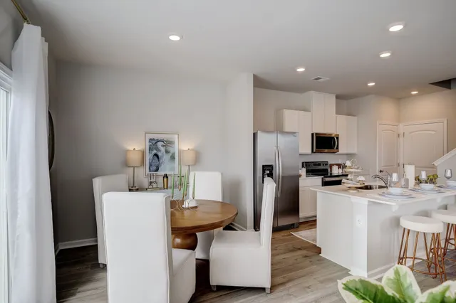 a kitchen with refrigerator and furniture