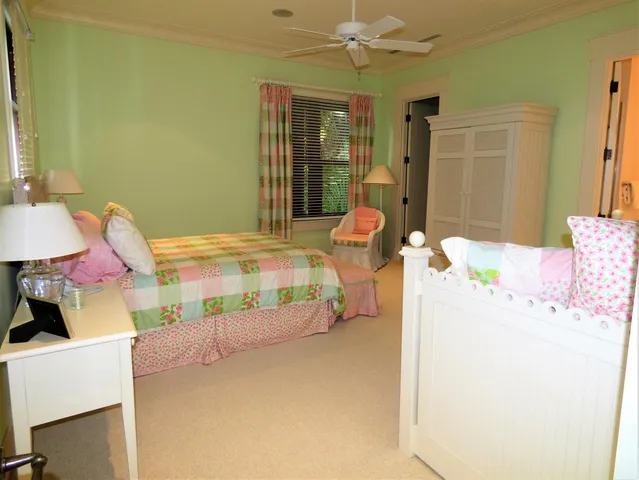 a bedroom with a bed dresser and a window