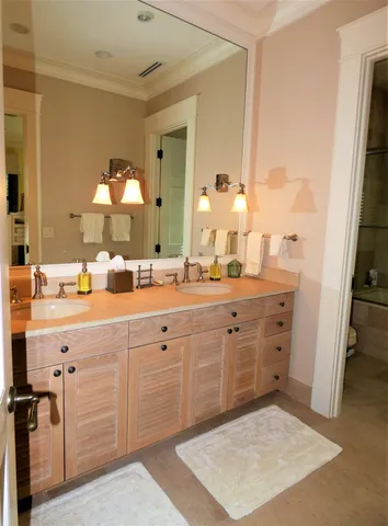 a spacious bathroom with a sink double vanity and a mirror