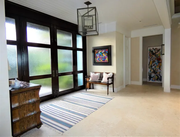 a living room with furniture a window and a flat screen tv