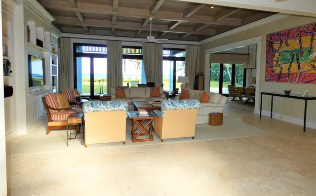 a living room with patio furniture and a large window