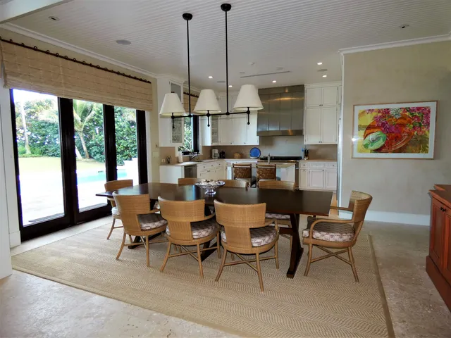 a dining room with furniture a chandelier and wooden floor