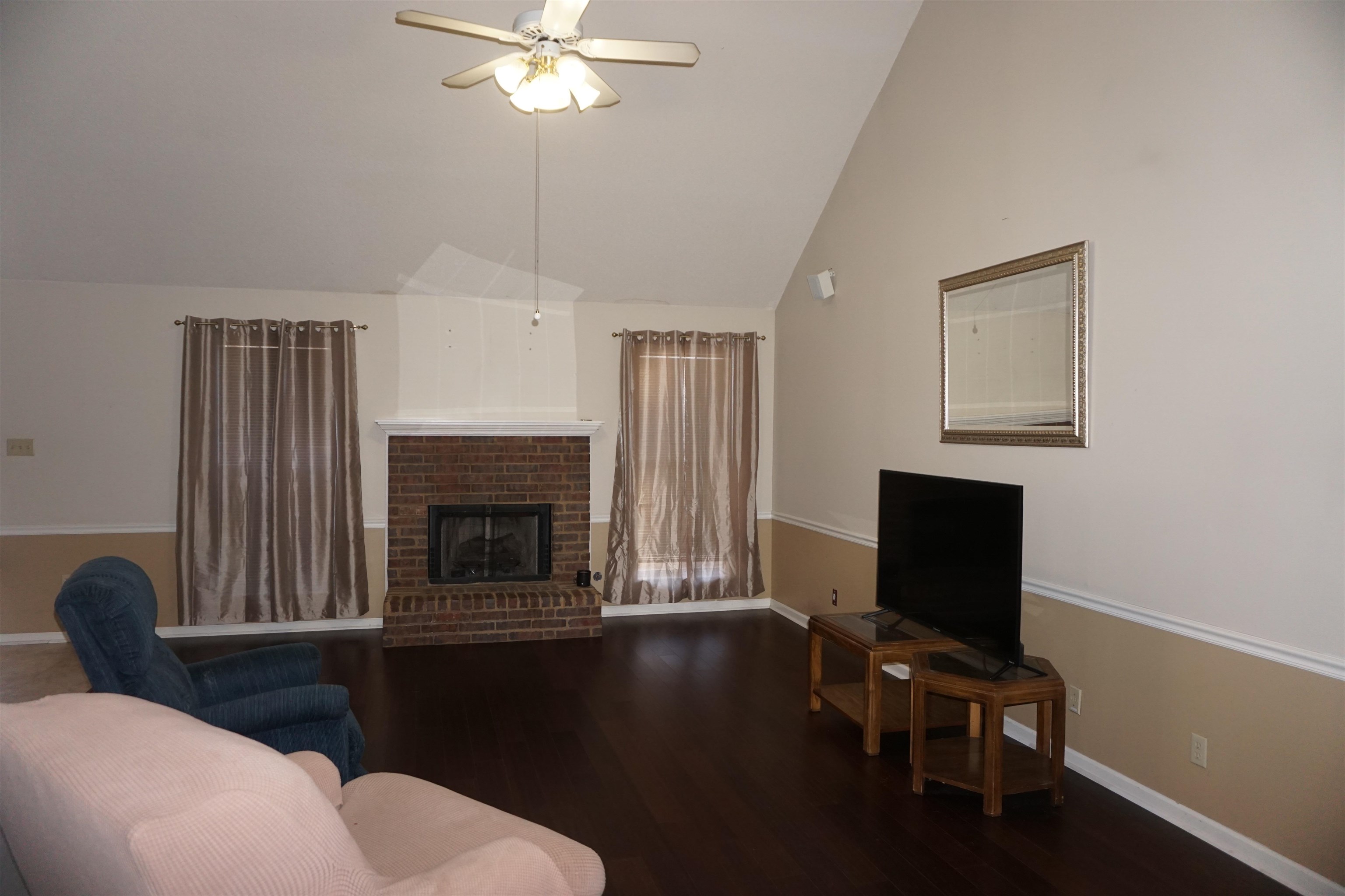 6835 Andrews Road Bartlett, TN 38135 - Photo 6 of 12 Living room with ceiling fan, vaulted ceiling, a fireplace, and dark hardwood / wood-style flooring