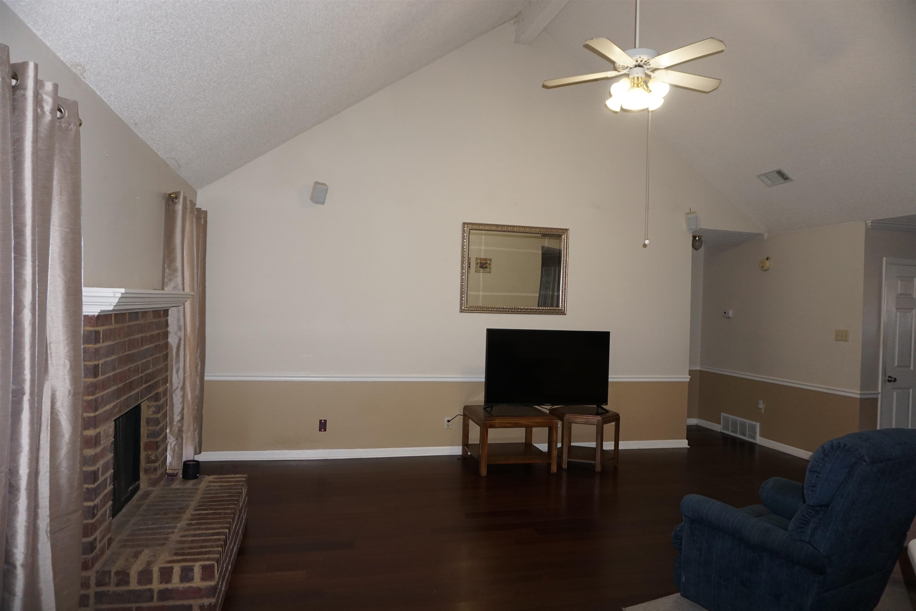 6835 Andrews Road Bartlett, TN 38135 - Photo 7 of 12 Living room with ceiling fan, a fireplace, dark hardwood / wood-style floors, and lofted ceiling with beams
