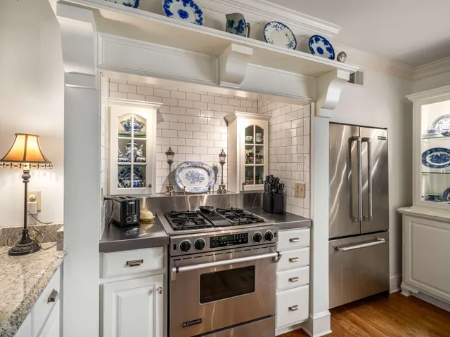 a bathroom with a sink double vanity granite tub shower and mirror