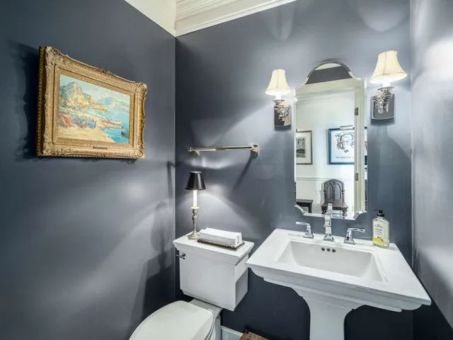 a bathroom with a toilet a sink and mirror