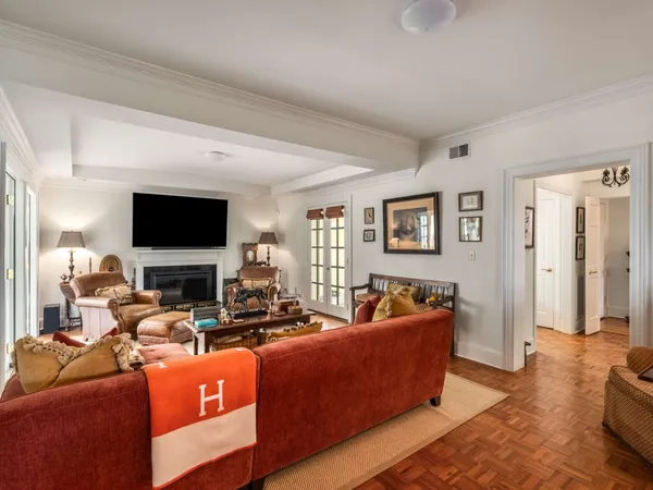 a living room with fireplace furniture and a book shelf