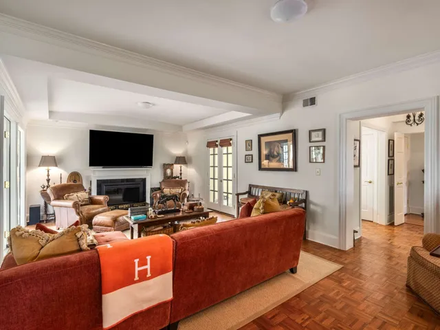 a living room with fireplace furniture and a book shelf
