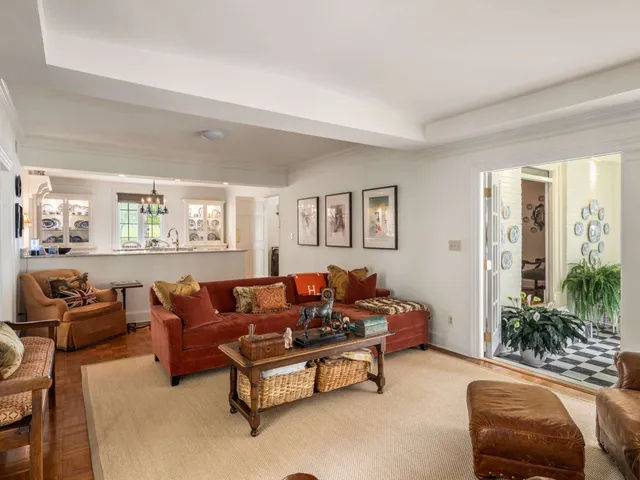 a living room with furniture and a chandelier