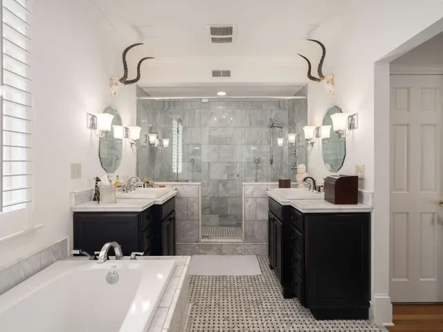 a living room with furniture a rug and a bookshelf