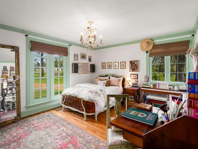 a living room with furniture a flat screen tv and a table