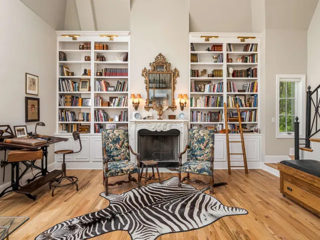 a living room with furniture dining table and a wooden floor