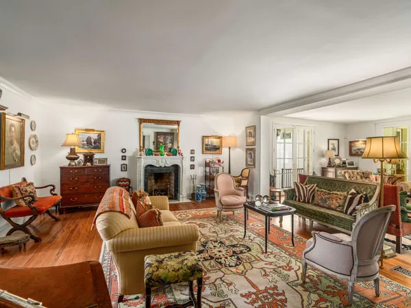 a dining room with furniture a window and wooden floor