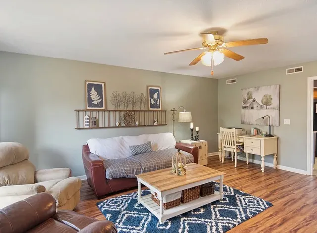 a living room with furniture and wooden floor