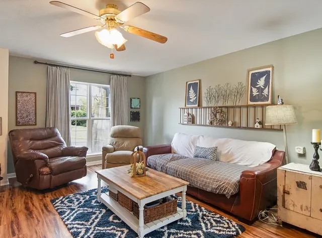a living room with furniture and a large window