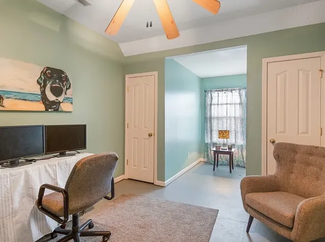 a view of a livingroom with workspace and a couch