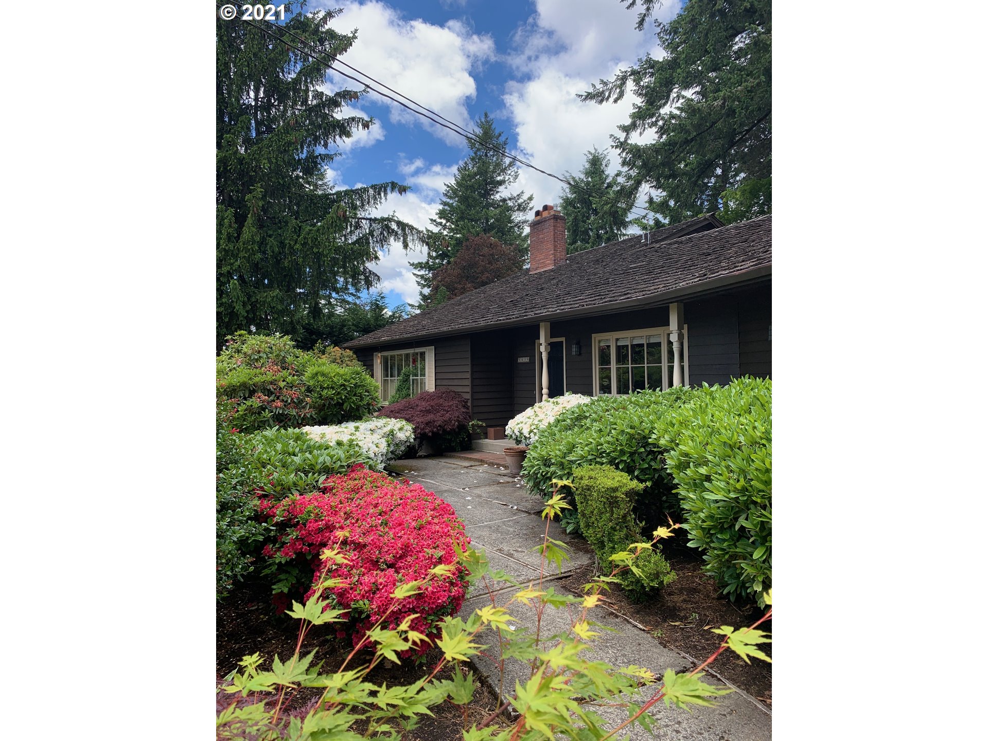 3939 Southwest Altadena Avenue Portland, OR 97239 - Photo 1 of 31 a front view of a house with a yard