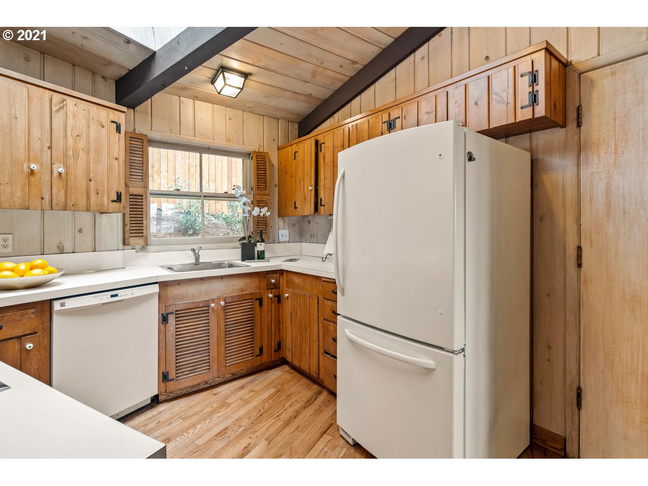 3939 Southwest Altadena Avenue Portland, OR 97239 - Photo 11 of 31 a white refrigerator freezer sitting inside of a kitchen