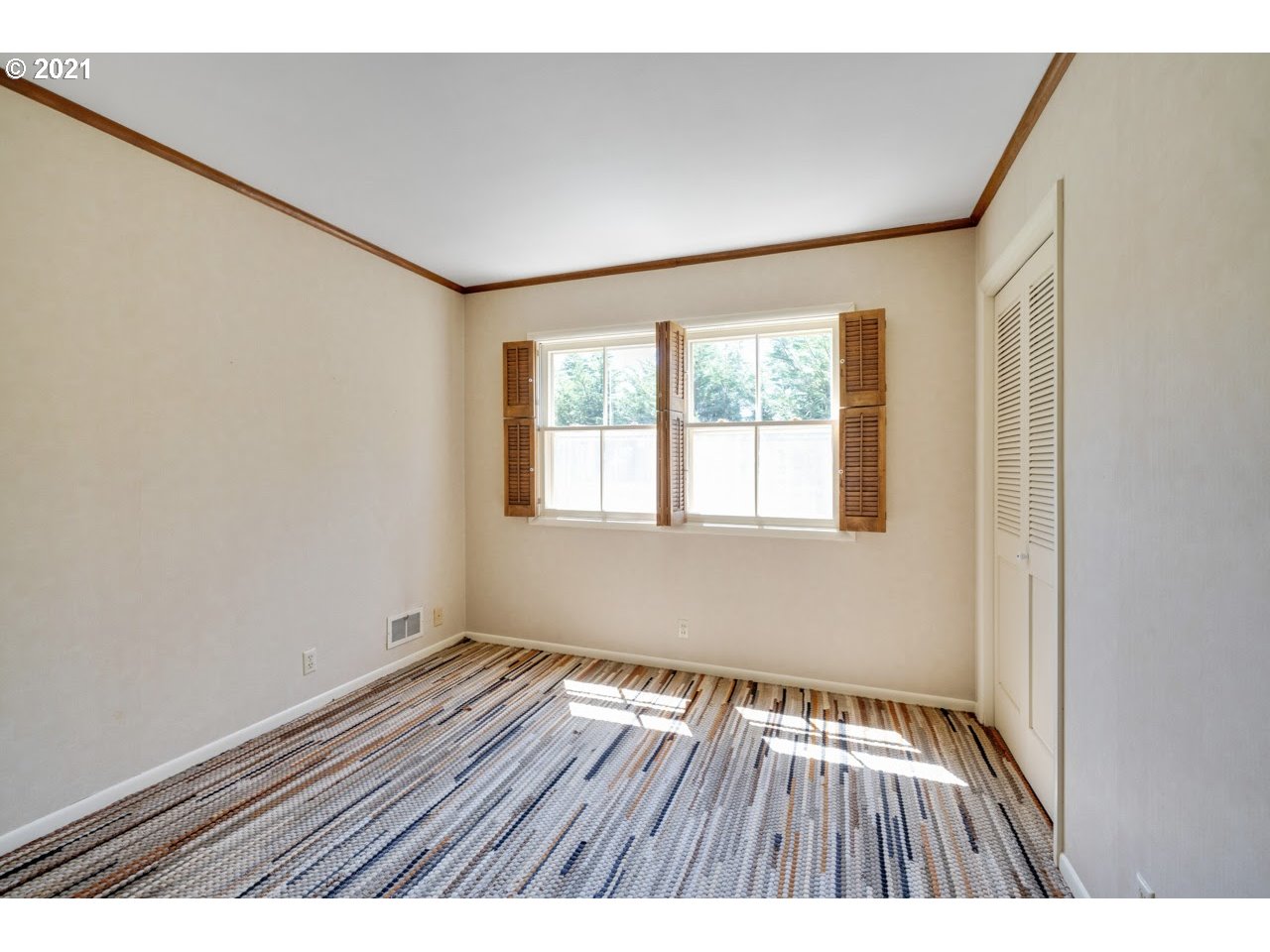 3939 Southwest Altadena Avenue Portland, OR 97239 - Photo 17 of 31 a view of an empty room with wooden floor and a window