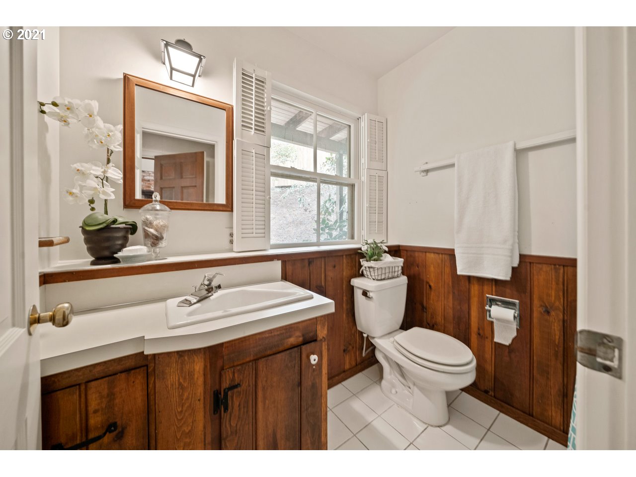 3939 Southwest Altadena Avenue Portland, OR 97239 - Photo 21 of 31 a bathroom with a sink a toilet a mirror and window