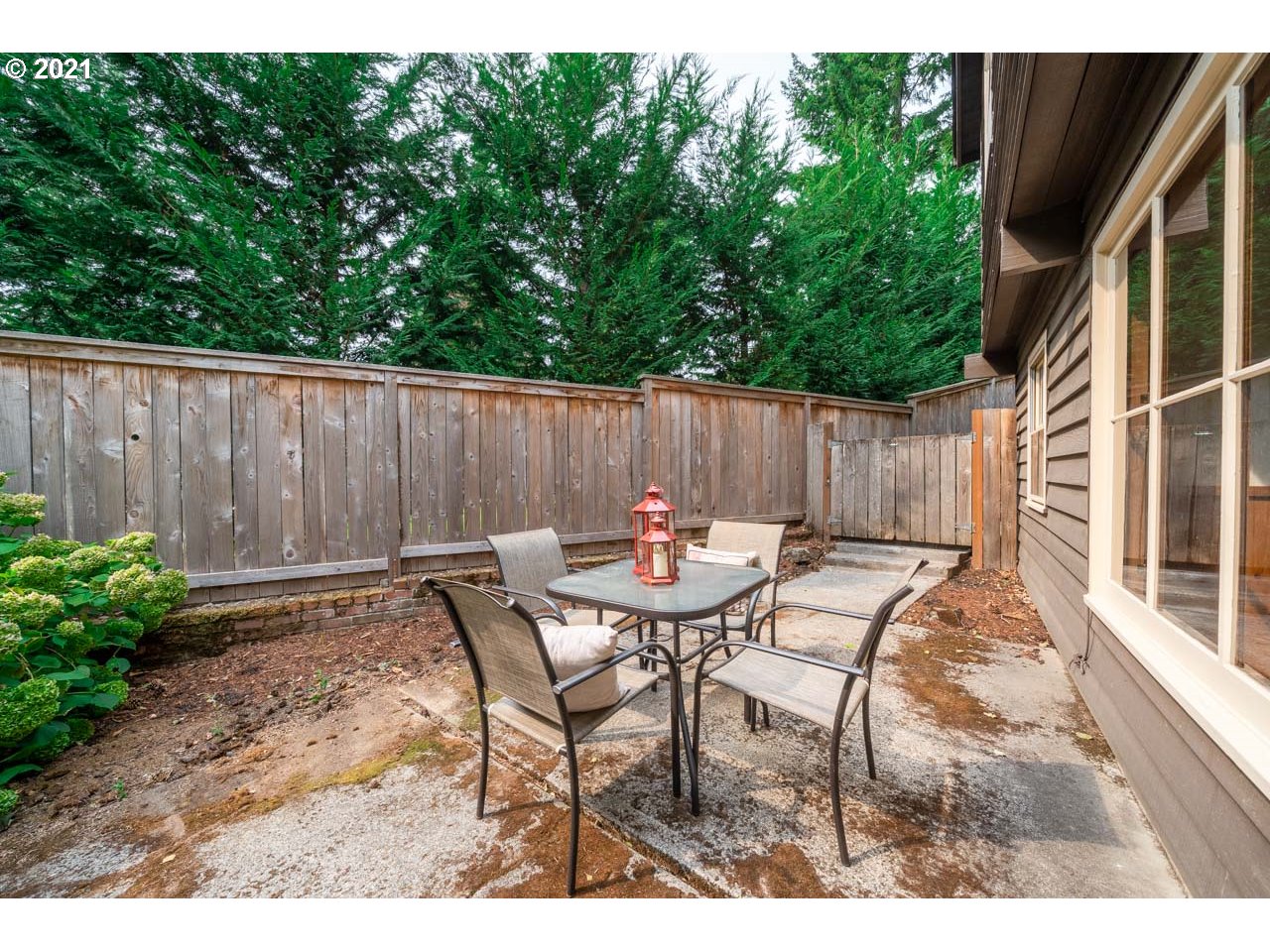 3939 Southwest Altadena Avenue Portland, OR 97239 - Photo 25 of 31 a view of backyard with table and chairs and wooden fence