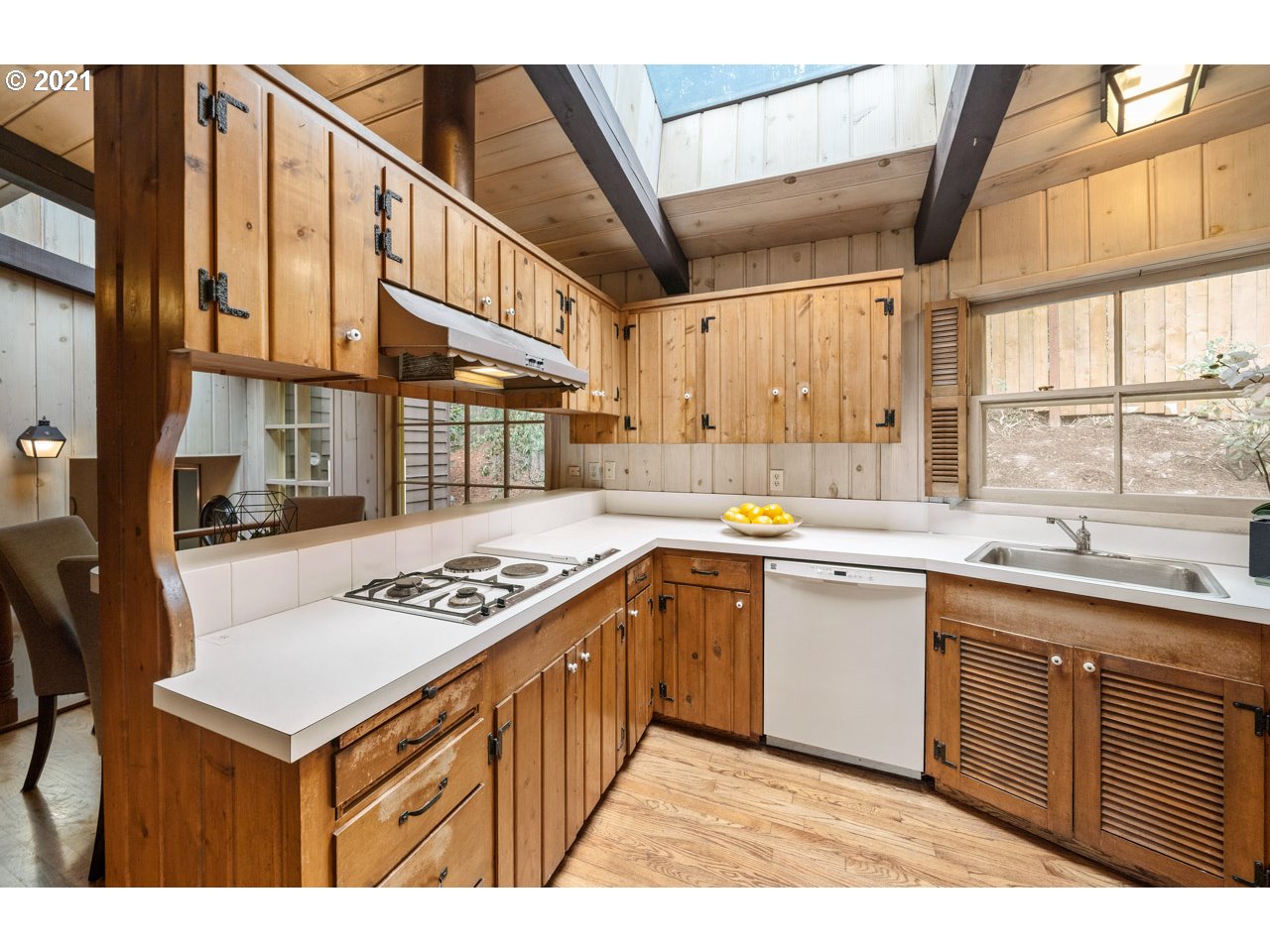 3939 Southwest Altadena Avenue Portland, OR 97239 - Photo 9 of 31 a kitchen with a stove a sink and a refrigerator