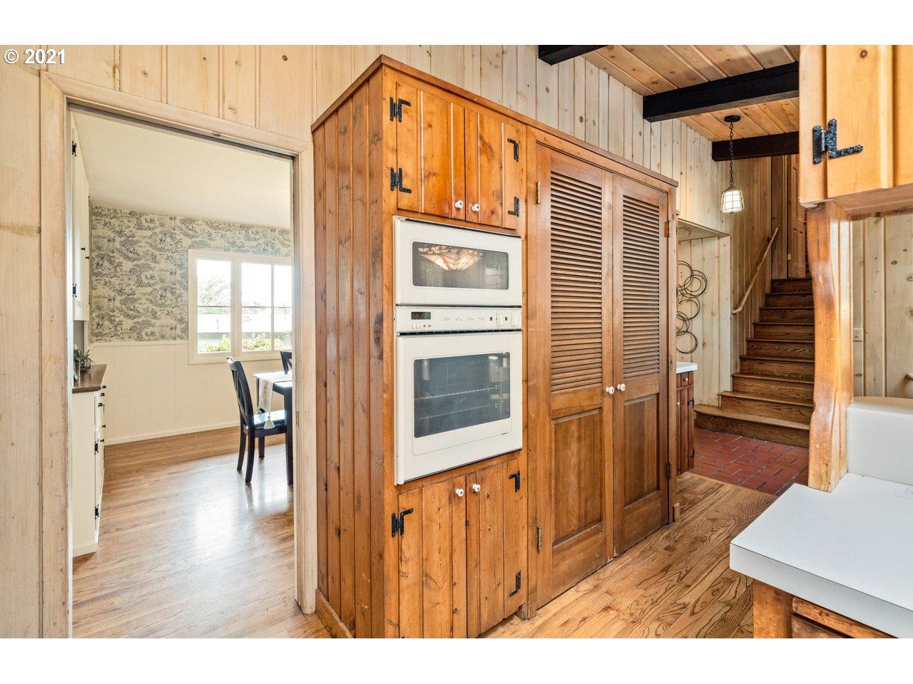 3939 Southwest Altadena Avenue Portland, OR 97239 - Photo 10 of 31 a view of a hallway with wooden floor and stairs
