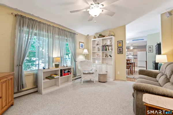 a living room with furniture and a large window
