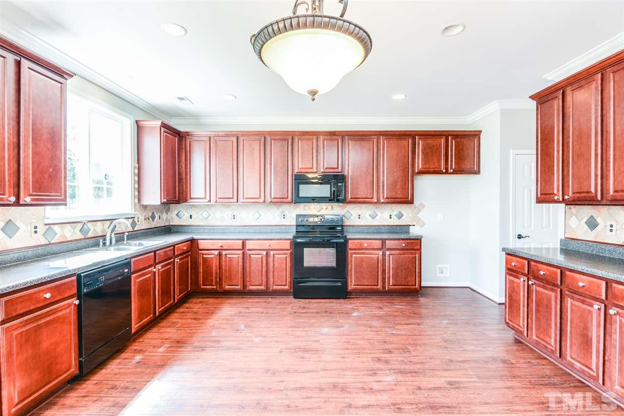 136 Ryder Cup Circle Raleigh, NC 27603 - Photo 2 of 17 a large kitchen with stainless steel appliances granite countertop a stove a sink dishwasher and a refrigerator